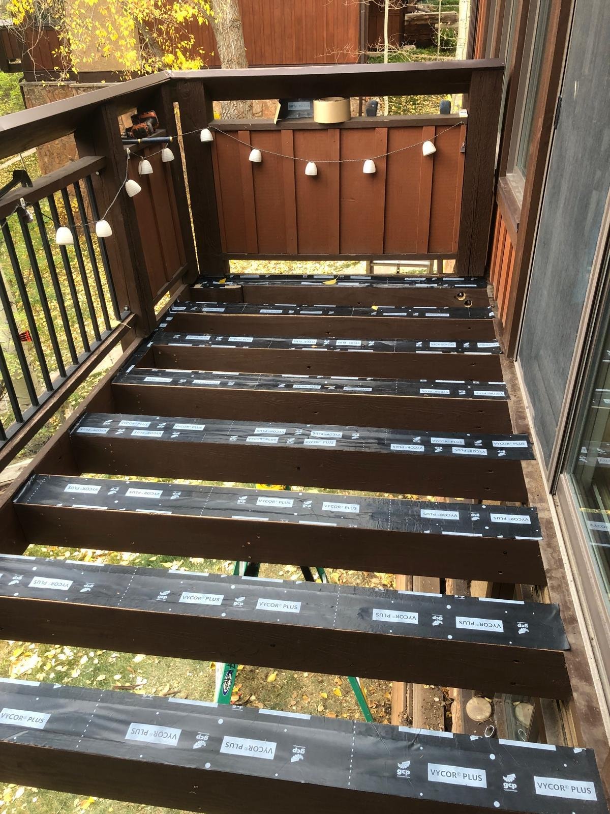 Custom deck with stained railing overlooking a hillside in the Colorado mountains