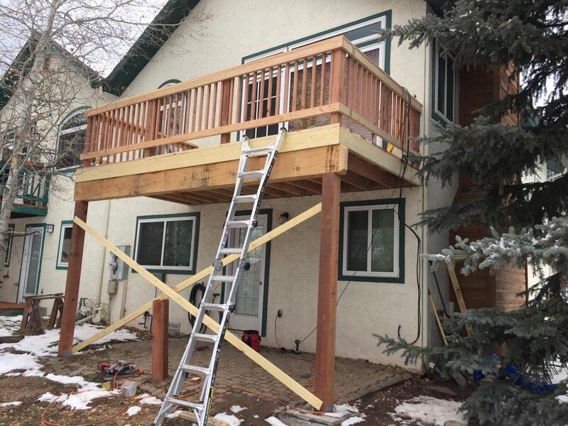 Deck stairs with new treads, wood railing and metal balusters